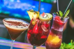 People celebrating at Zoo Bar Ibiza with drinks raised