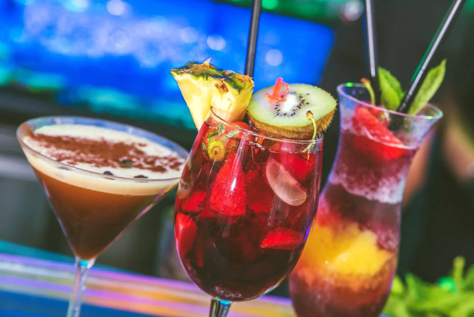 People celebrating at Zoo Bar Ibiza with drinks raised