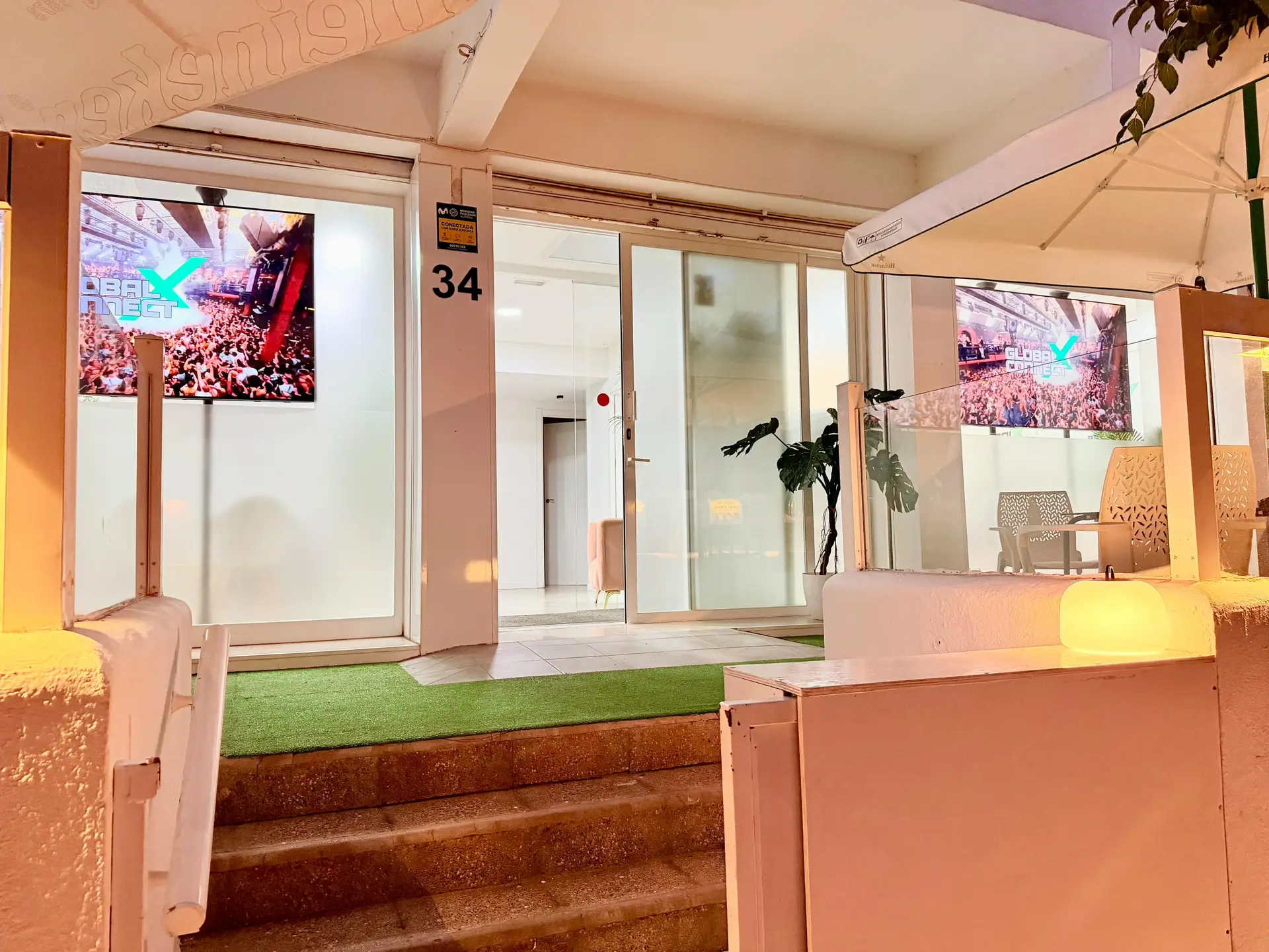 GXC Ibiza office entrance lit up at night